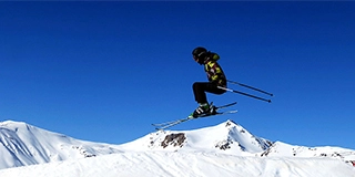 A man flying through the air while riding skis - Josef Pelikan