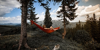 Person lying on red hammock - Max Vertsanov